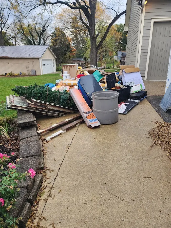 Dumpster being loaded with debris for Estate Cleanout Dumpster Rental in South Portland